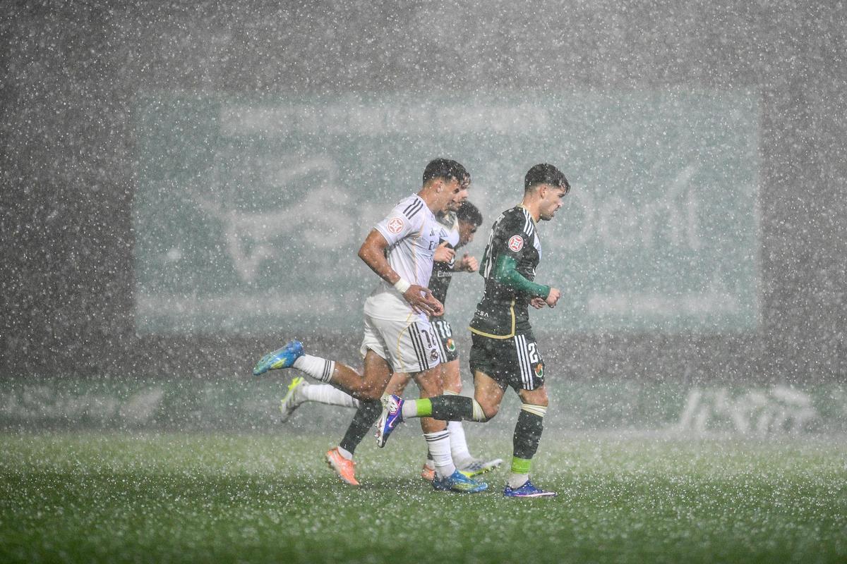 Los jugadores se retiran por la tormenta, con José Alonso en primer plano.