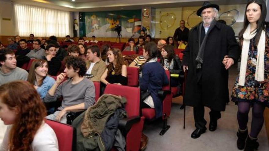 José Luis García Rúa, de la mano de Alba García, una de las organizadoras de la charla, en la Facultad de Derecho.