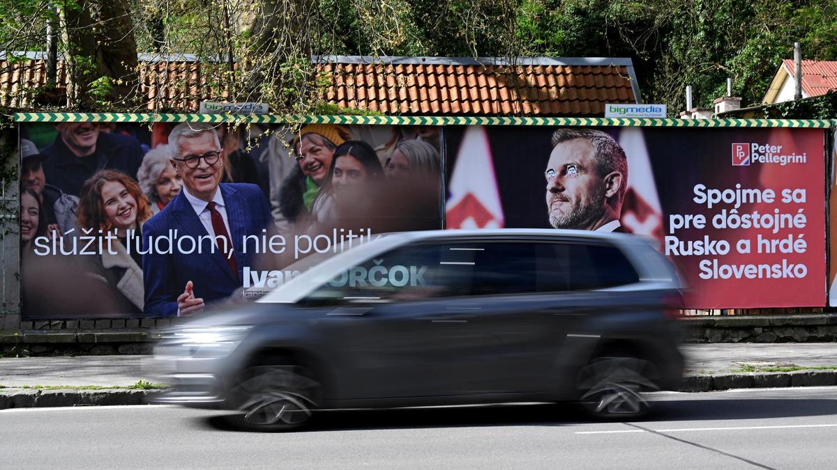 Un vehículo pasa junto a carteles electorales de los candidatos Ivan Korkok y Peter Pellegrini, este viernes en Trencin.