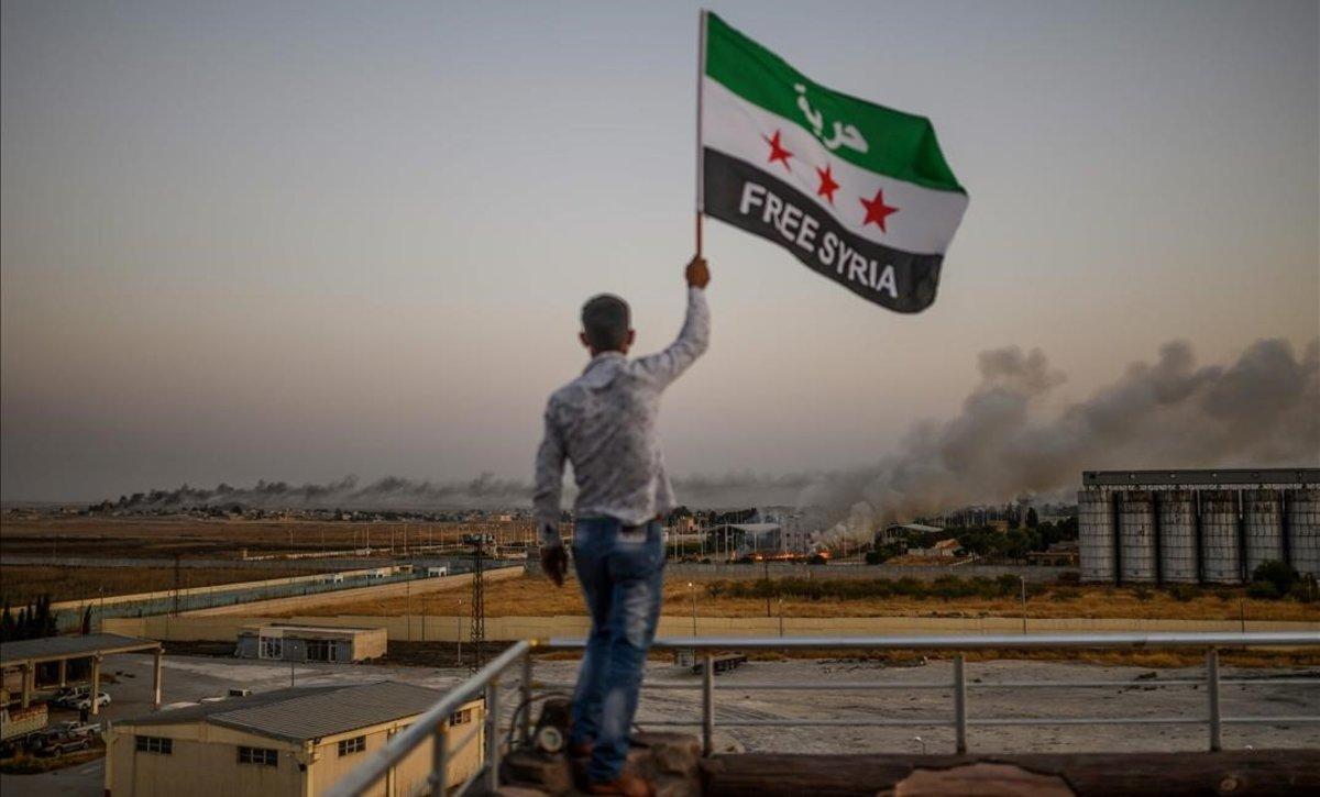 zentauroepp50384481 a man waves a syrian opposition flag reading  free syria  on191013183248