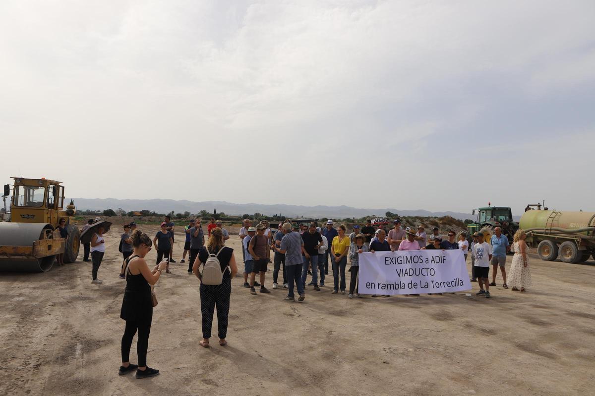 Decenas de vecinos 'tomaban' el punto en que las vías 'cortarán' el cauce.