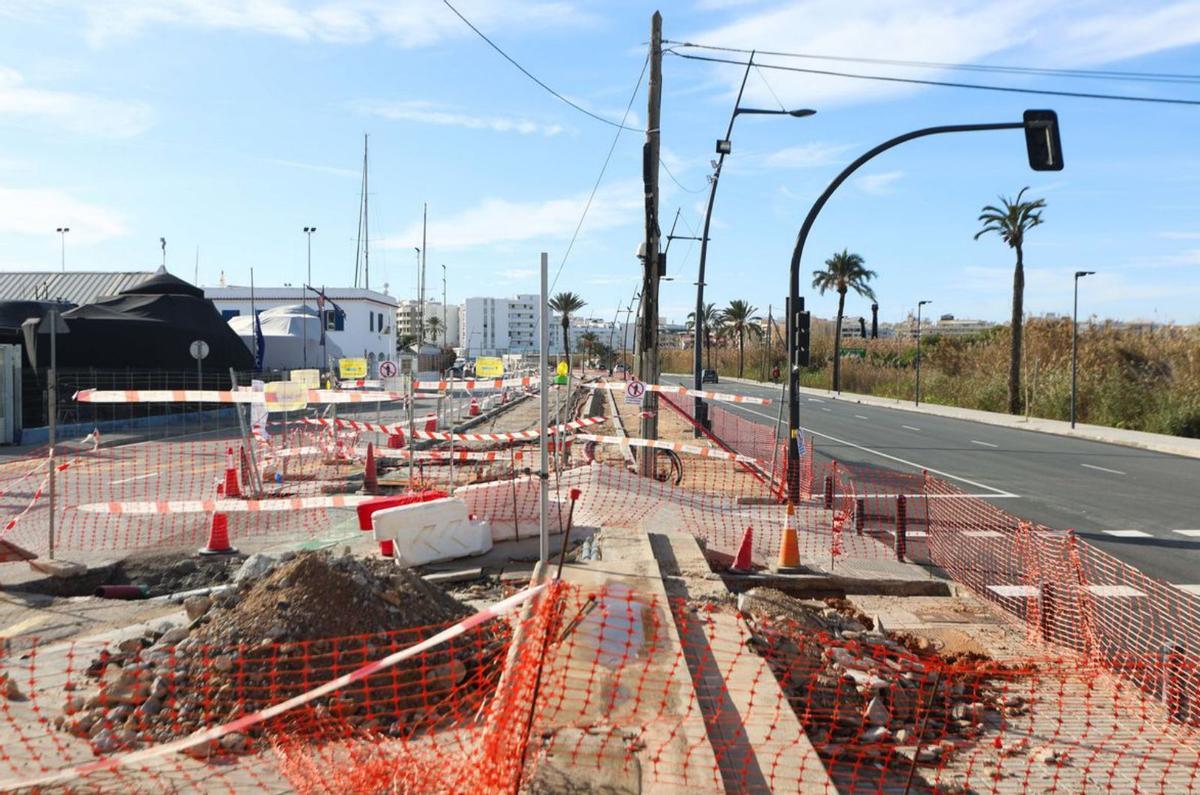 Dos transeúntes, a la izquierda, pasean cerca de las obras. | TONI ESCOBAR