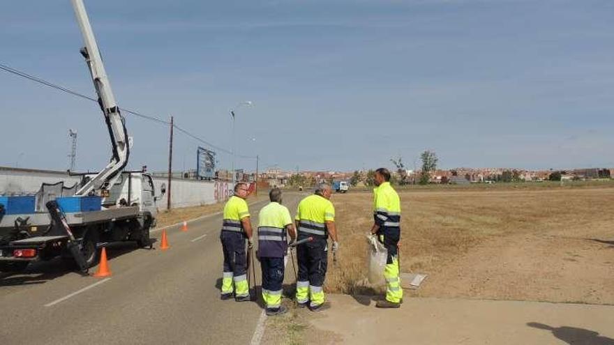 Operarios municipales vallan la zona de aparcamientos junto al campo de fútbol