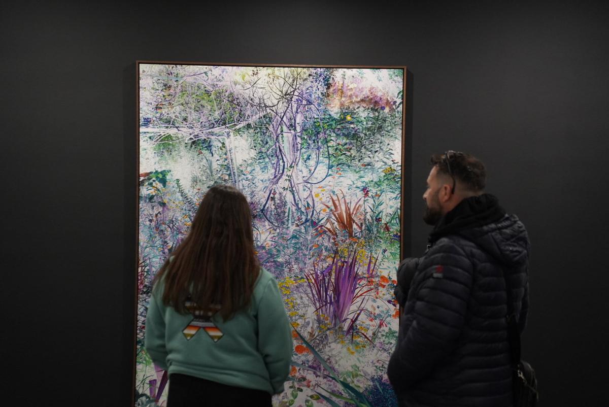 Dos jóvenes contemplan la obra ganadora del 13º Premio Pilar Citoler, que se exhibe en UCOCultura.