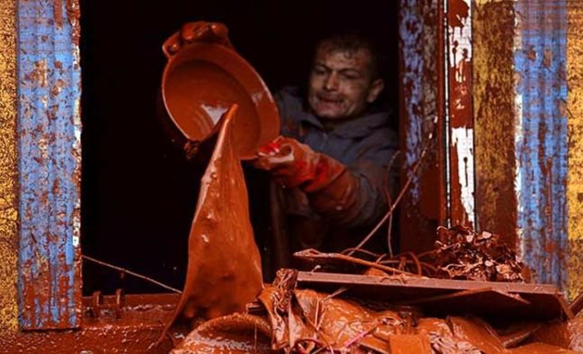 Un home treu fang tòxic de casa seva amb l’ajuda d’una galleda.
