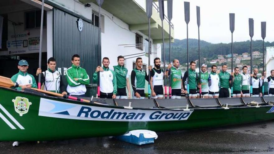 La tripulación masculina de Meira junto a su trainera, con la que competirán en la Liga Gallega.