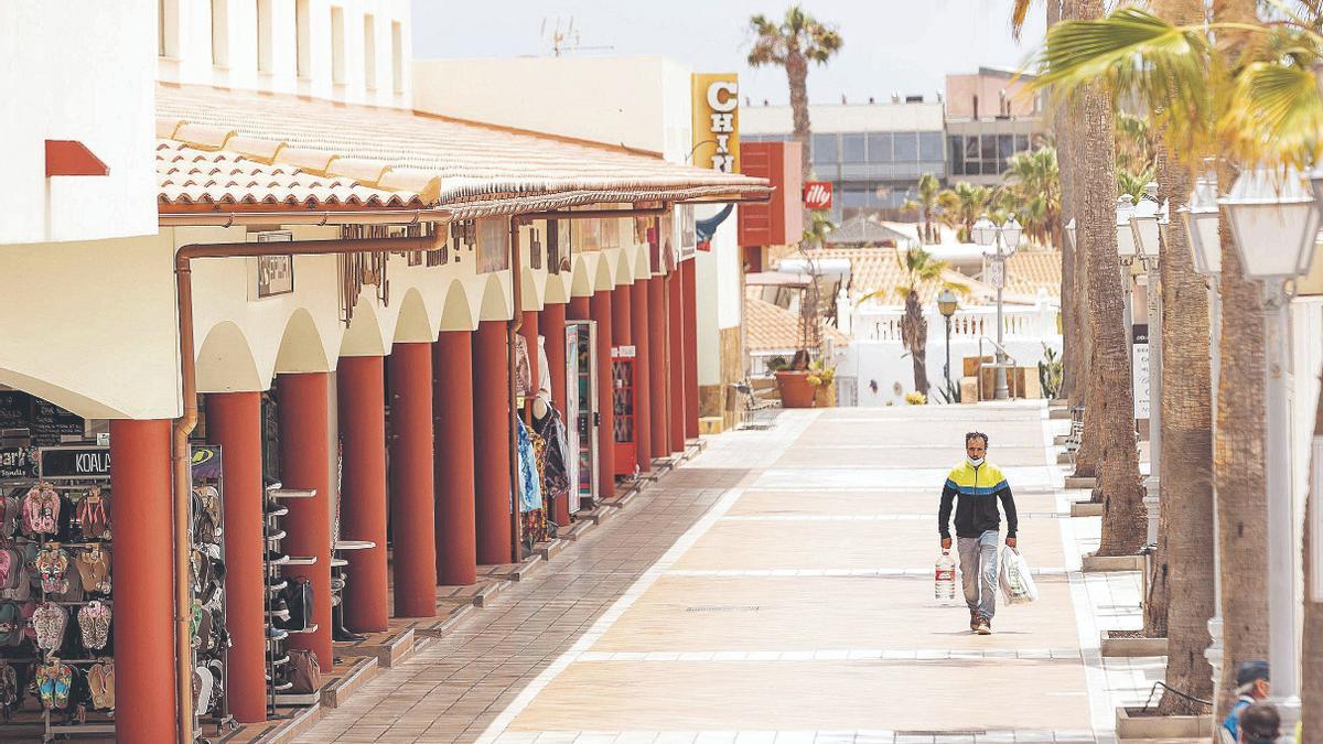 Un ciudadano camina por uno de los centros comerciales más populares de la zona turística de Caleta de Fuste, en el municipio de Antigua.