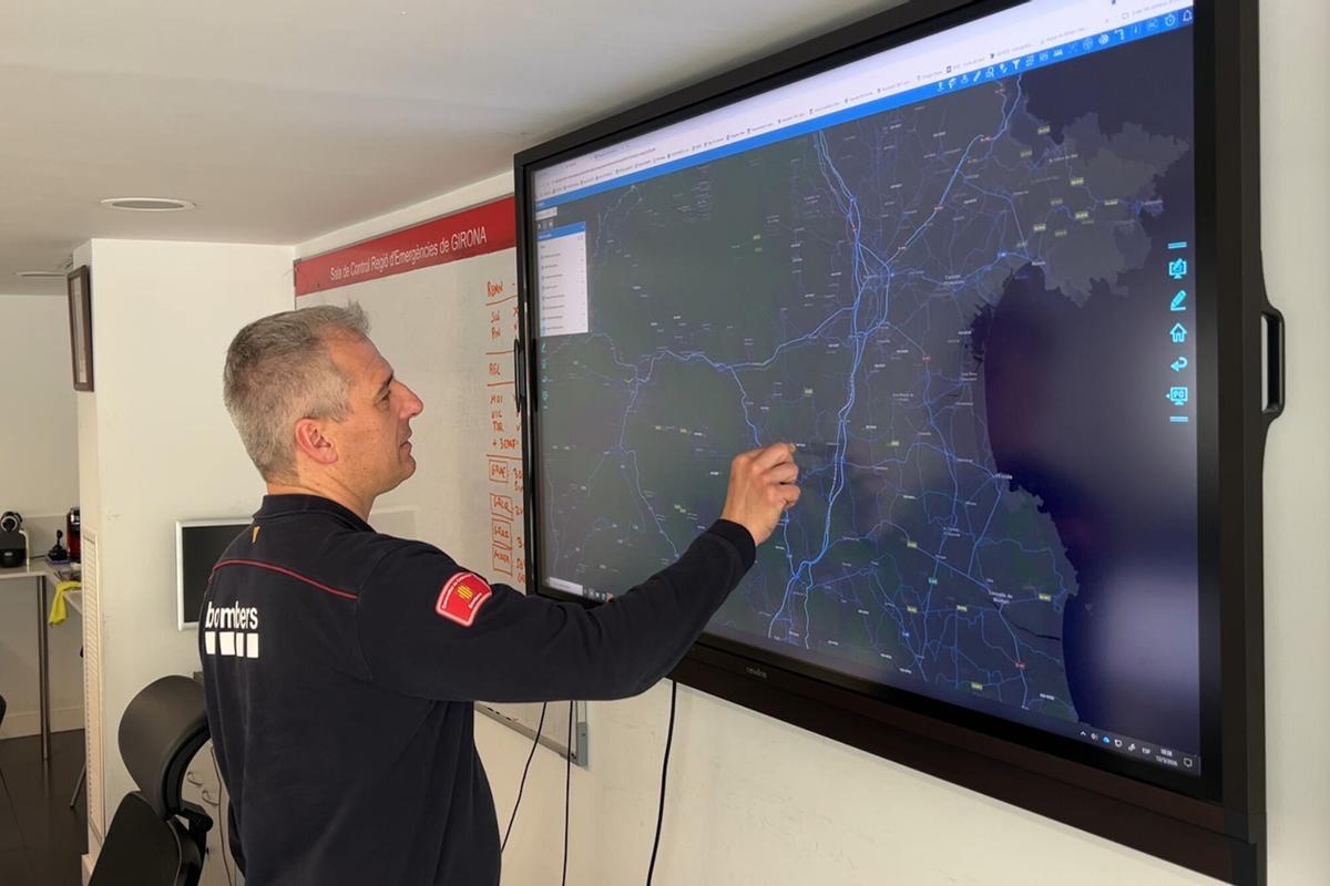 Un dels caps territorials de bombers de la Regió d'Emergències de Girona, Jordi Marquès, mirant el mapa d'avisos