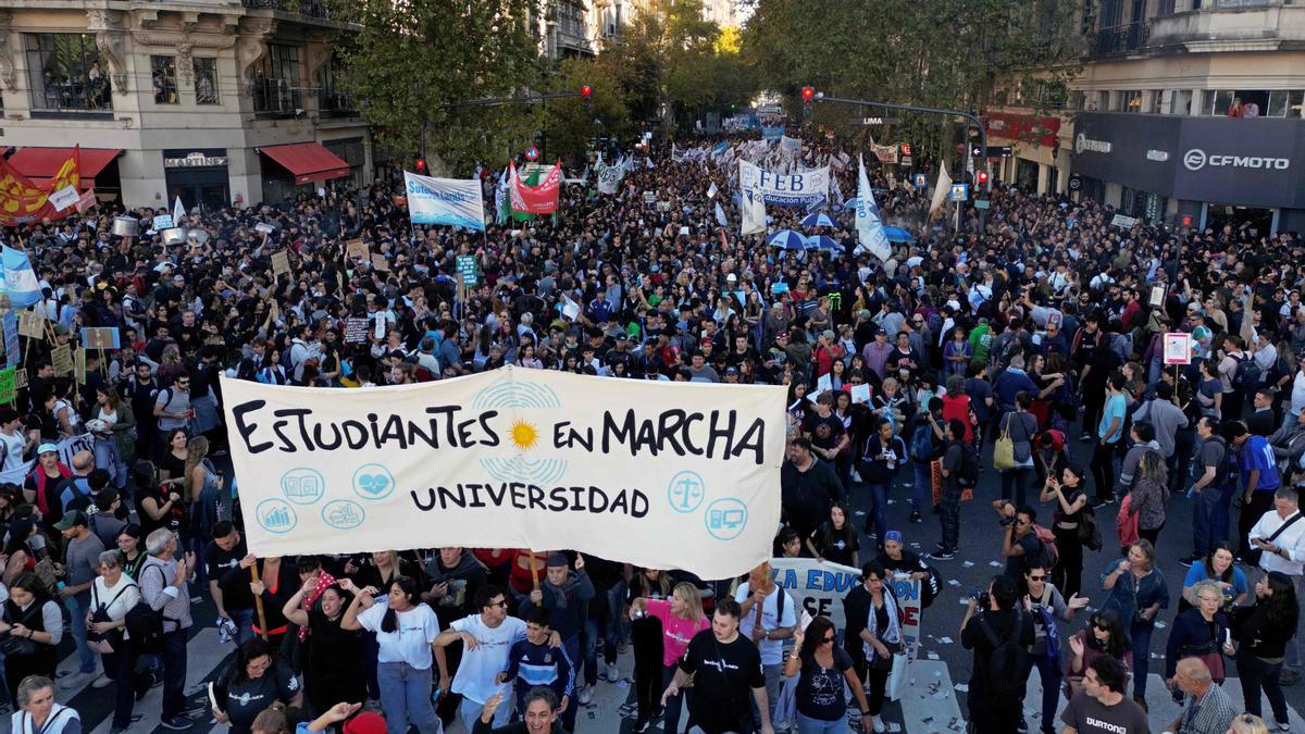 Demonstrators march in protest of the budget adjustment to public universities in Buenos Aires on April 23, 2024. Thousands of university students took to the streets of Argentina on Tuesday to repudiate the defunding of the public university, which was declared in a state of budgetary emergency in the framework of the adjustment policy of the right-wing president Javier Milei. (Photo by Luis ROBAYO / AFP)