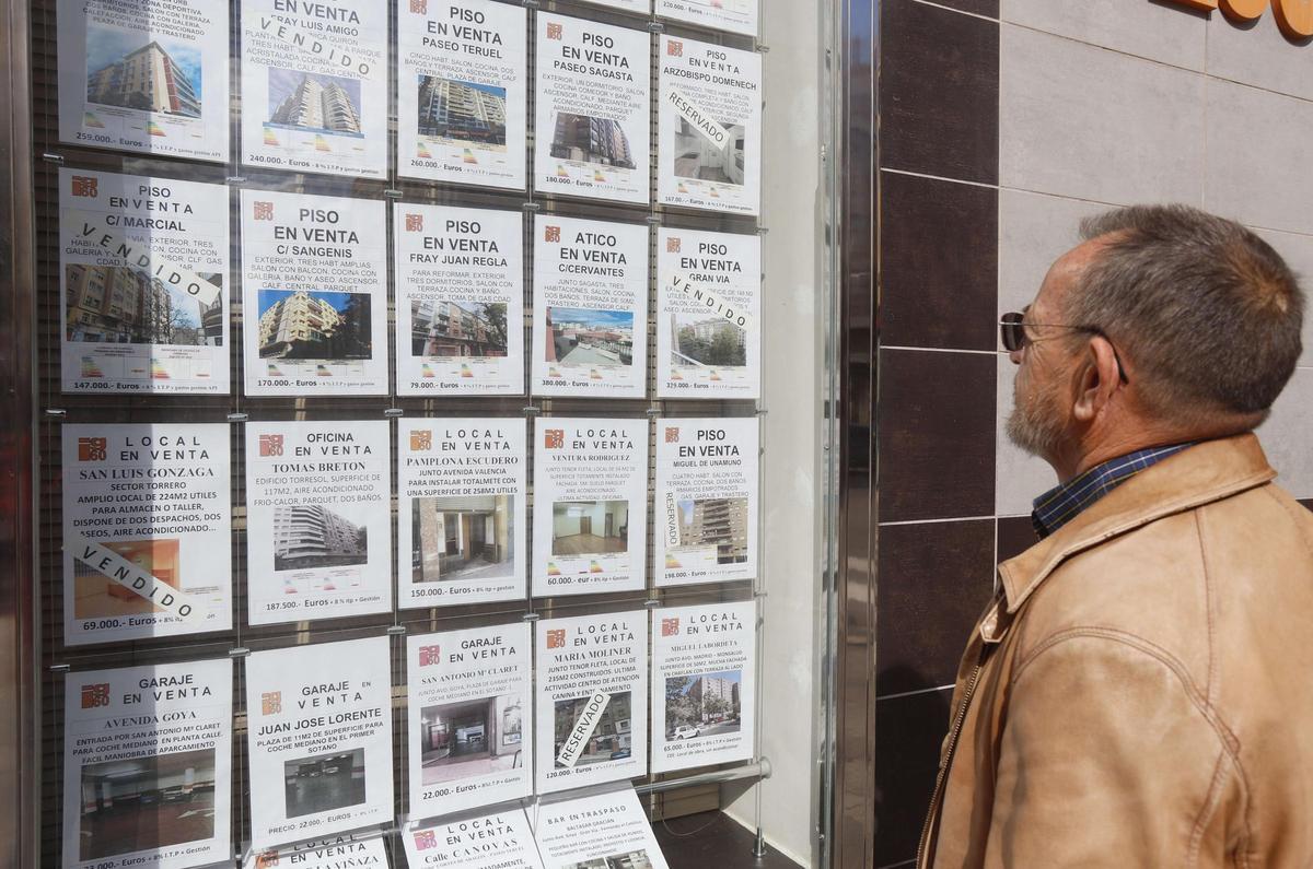 Un vecino observa las ofertas de una inmobiliaria de Zaragoza, en una imagen de archivo.