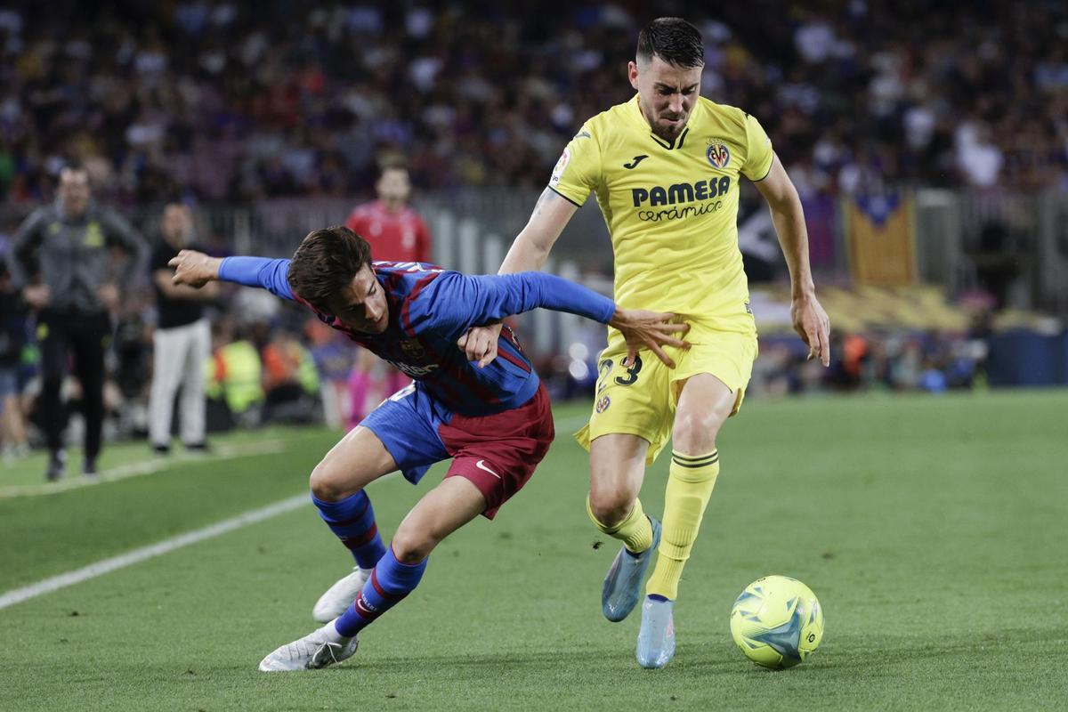 Barcelona’s Riqui Puig (L) in action agaisnt Villarreal’s Moi Gomez (R) during their Spanish LaLiga soccer match between FC Barcelona and Villarreal CF at Camp Nou stadium in Barcelona, Catalonia, Spain, 22 May 2022. EFE/Quique Garcia