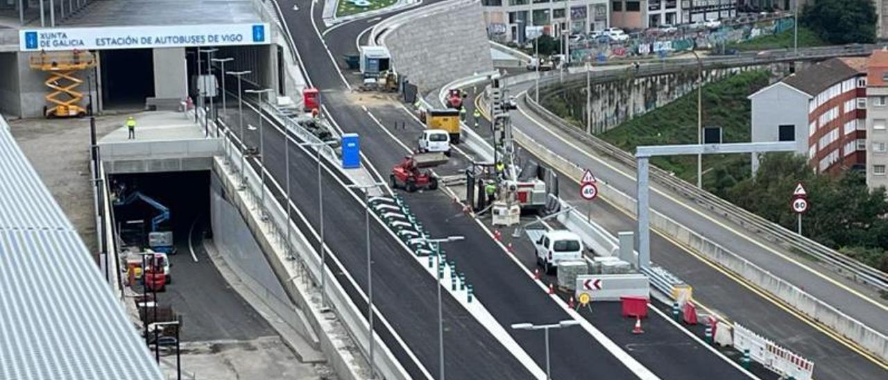 Vehículos de las obras del Halo en el carril de acceso a la estación y uno en el de salida. |   // FDV