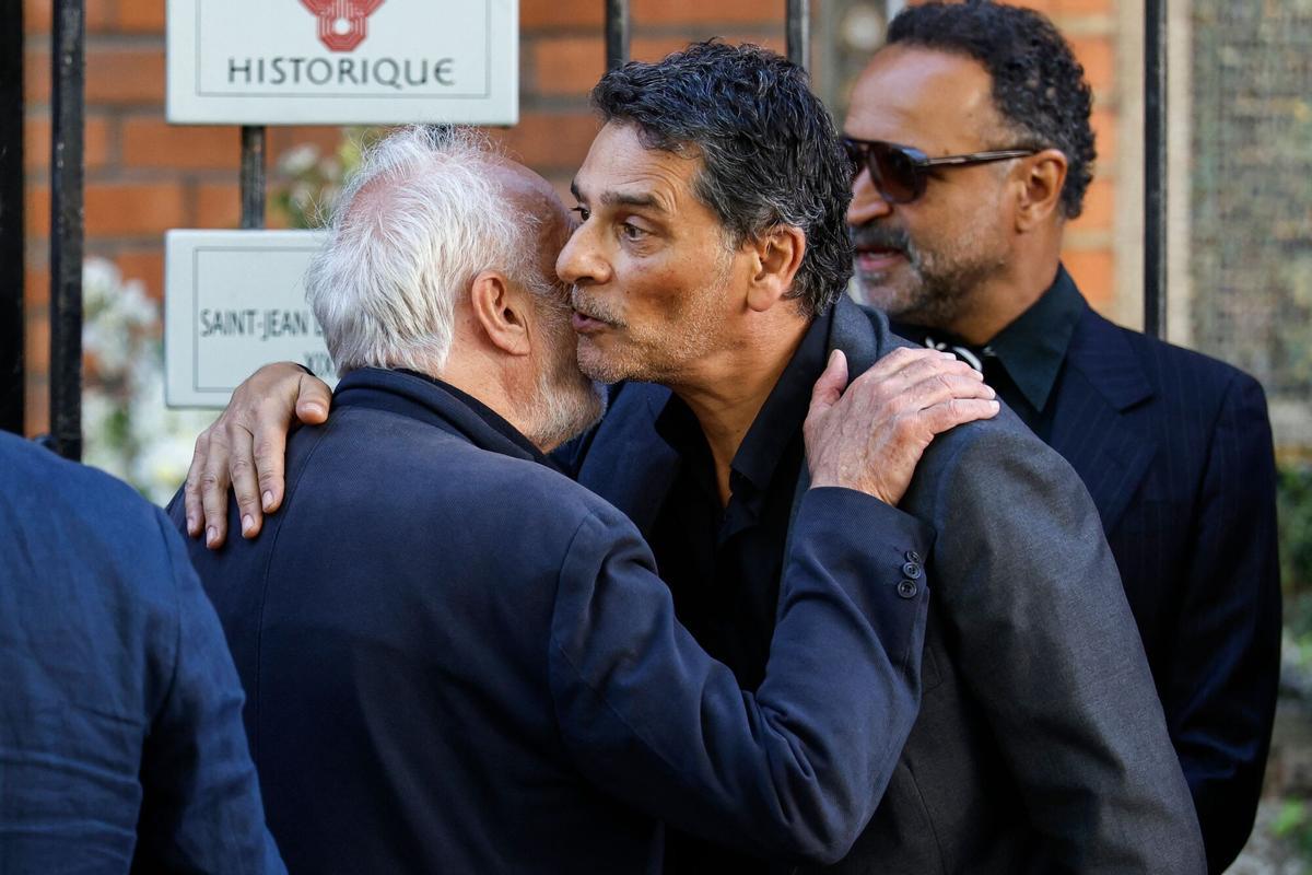 French actor Francois Berleand (L) greets actor Pascal Elbe upon arrival for the funeral ceremony of French actress Nadia Fares at the Saint-Jean de Montmartre church in Paris on April 24, 2026. Nadia Fares died on April 17, 2026, aged 57, after being found unconscious in a swimming pool in Paris and several days in a coma. (Photo by SIMON WOHLFAHRT / AFP)
