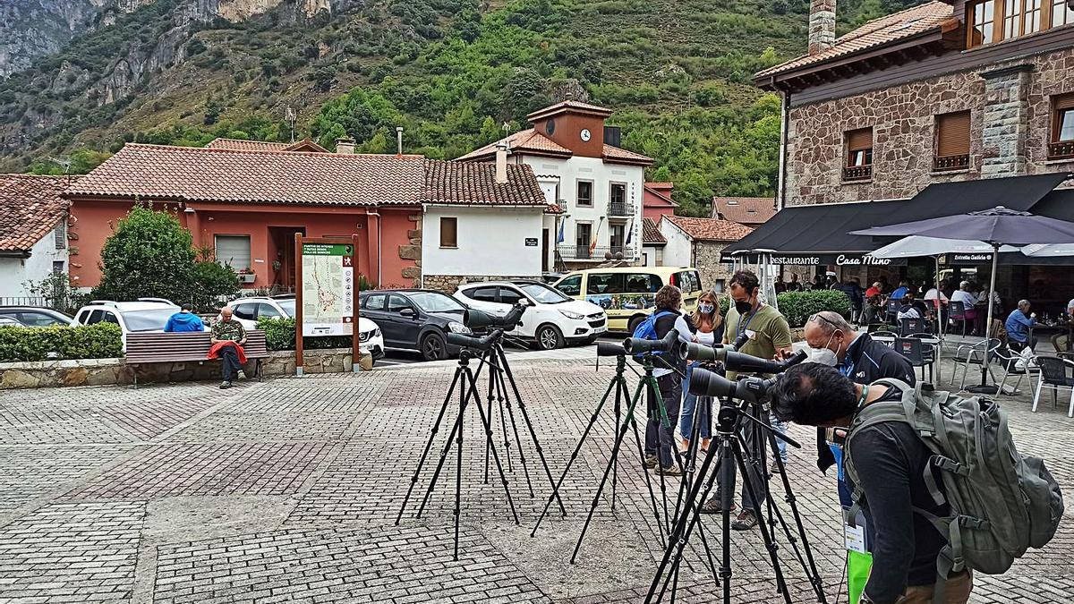 Participantes en “Nature Watch”, ayer, disfrutando de la observación de fauna en Pola de Somiedo. A la derecha, el público asistente a la inauguración. | S. Arias