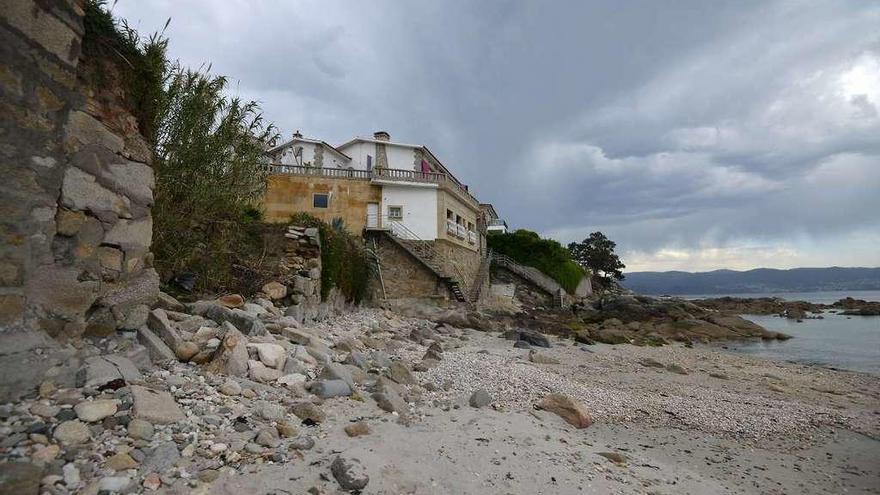 Estado actual de la playa de A Carabuxeira con los muros de las viviendas afectadas.  // G. Santos