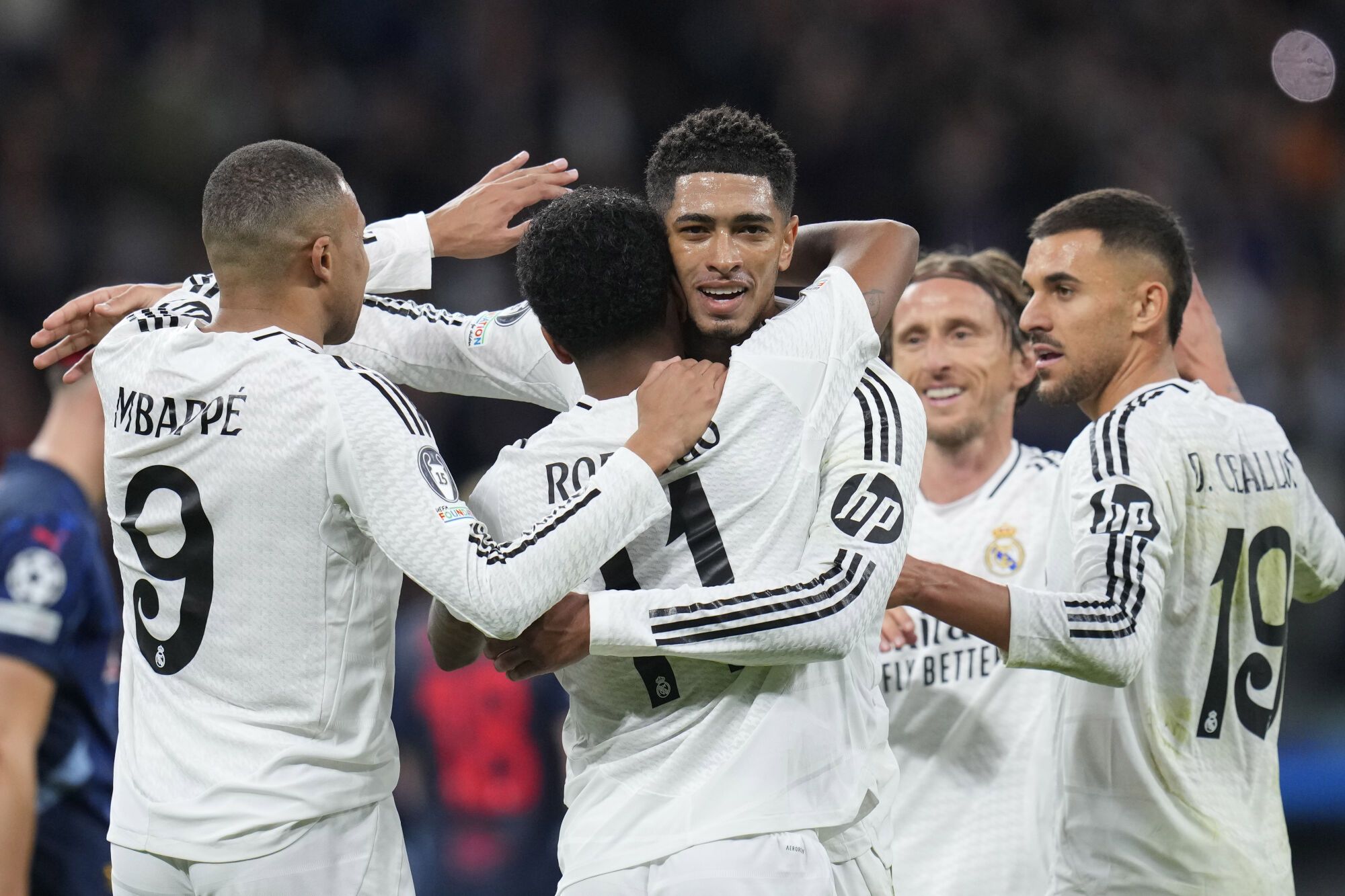 Real Madrid's Rodrygo celebrates with teammates after scoring his side's 2nd goal during the Champions League opening phase soccer match between Real Madrid and FC Salzburg at the Santiago Bernabeu stadium in Madrid, Wednesday, Jan. 22, 2025. (AP Photo/Manu Fernandez). EDITORIAL USE ONLY/ONLY ITALY AND SPAIN