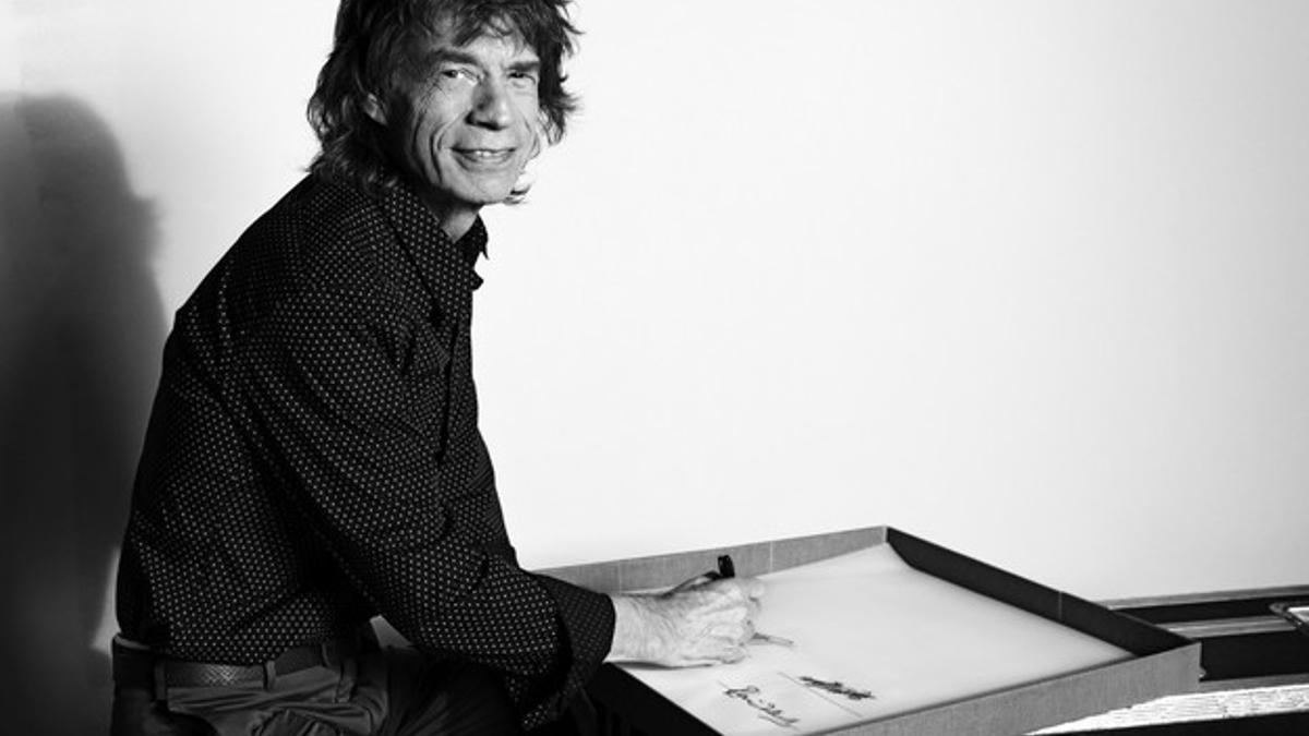 Fotografía facilitada por Taschen del vocalista de los Rolling Stones, Jack Jagger firmando un ejemplar del libro de más de 500 páginas.
