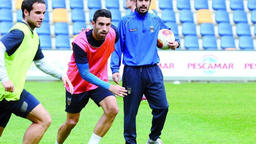 Manu Fernández, con el balón en la mano, atento a lo que hacen Moreira y David García.