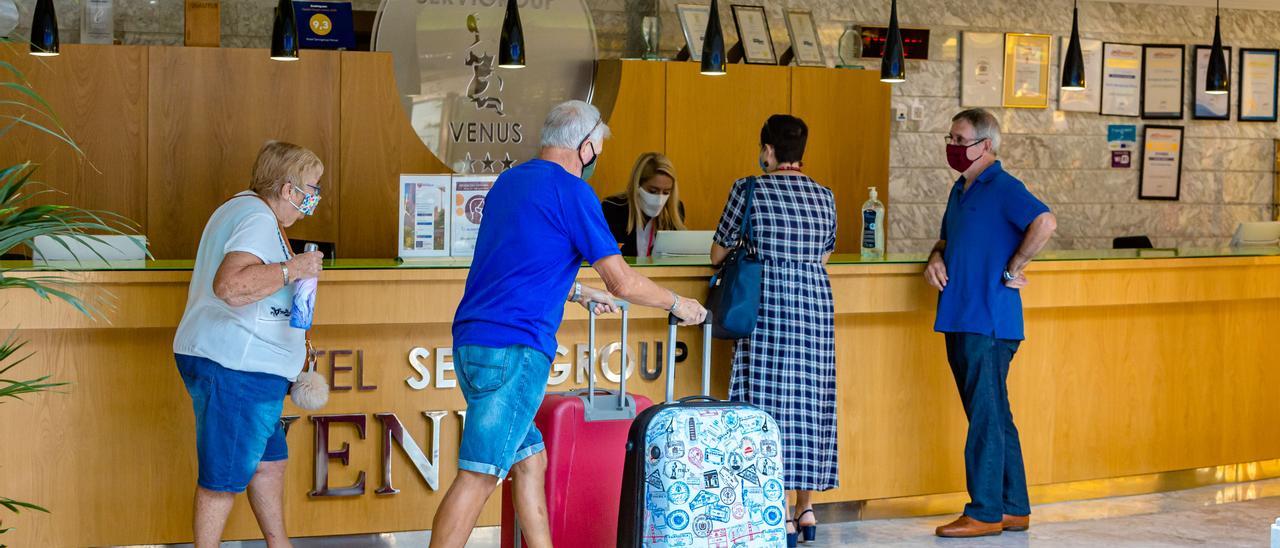 Turistas en la recepción de un hotel en Benidorm este otoño