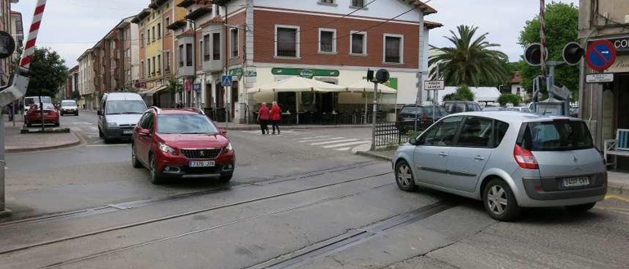 Coches atravesando el paso a nivel de Posada de Llanes, ayer.