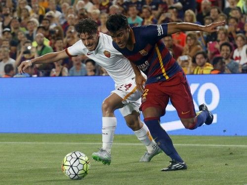 Barcelona's Rafinha fights for the ball against AS Roma's Alessandor Florenzi during a friendly match at Camp Nou stadium in Barcelona