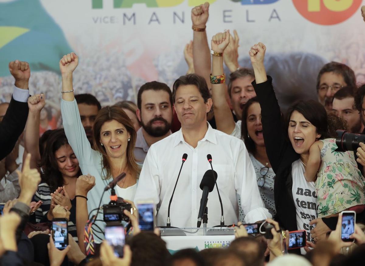 Flanked by his wife Ana Estela  left  and running mate Manuela d Avila  Workers  Party presidential candidate Fernando Haddad pauses during his concession speech while his staff and supporters cheer him on  in Sao Paulo  Brazil  Sunday  Oct  28  2018  Brazila  s Supreme Electoral Tribunal declared far-right congressman Jair Bolsonaro the next president of Latin Americaa  s biggest country   AP Photo Andre Penner