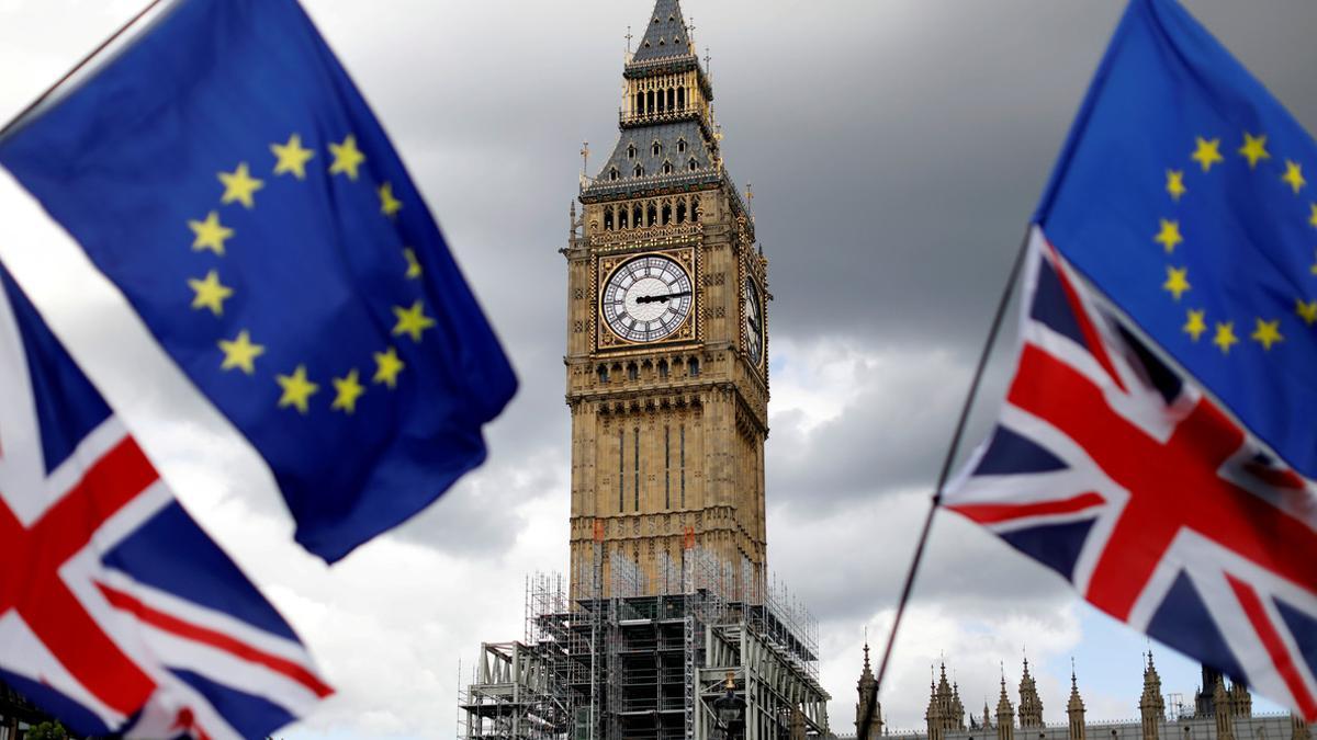 FILE PHOTO: Union Flags and European Union flags fly near the Elizabeth Tower, housing the Big Ben bell, during the anti-Brexit 'People's March for Europe', in Parliament Square in central London