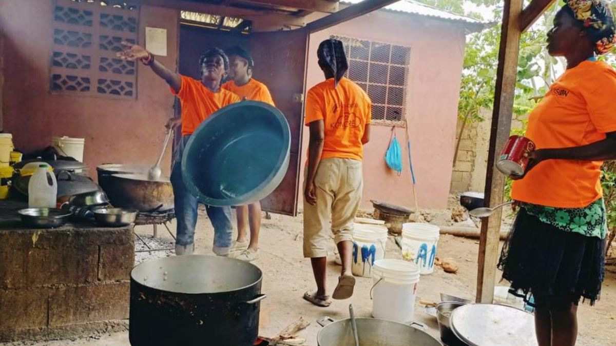 Varias cocineras preparan la comida para los niños del campamento.