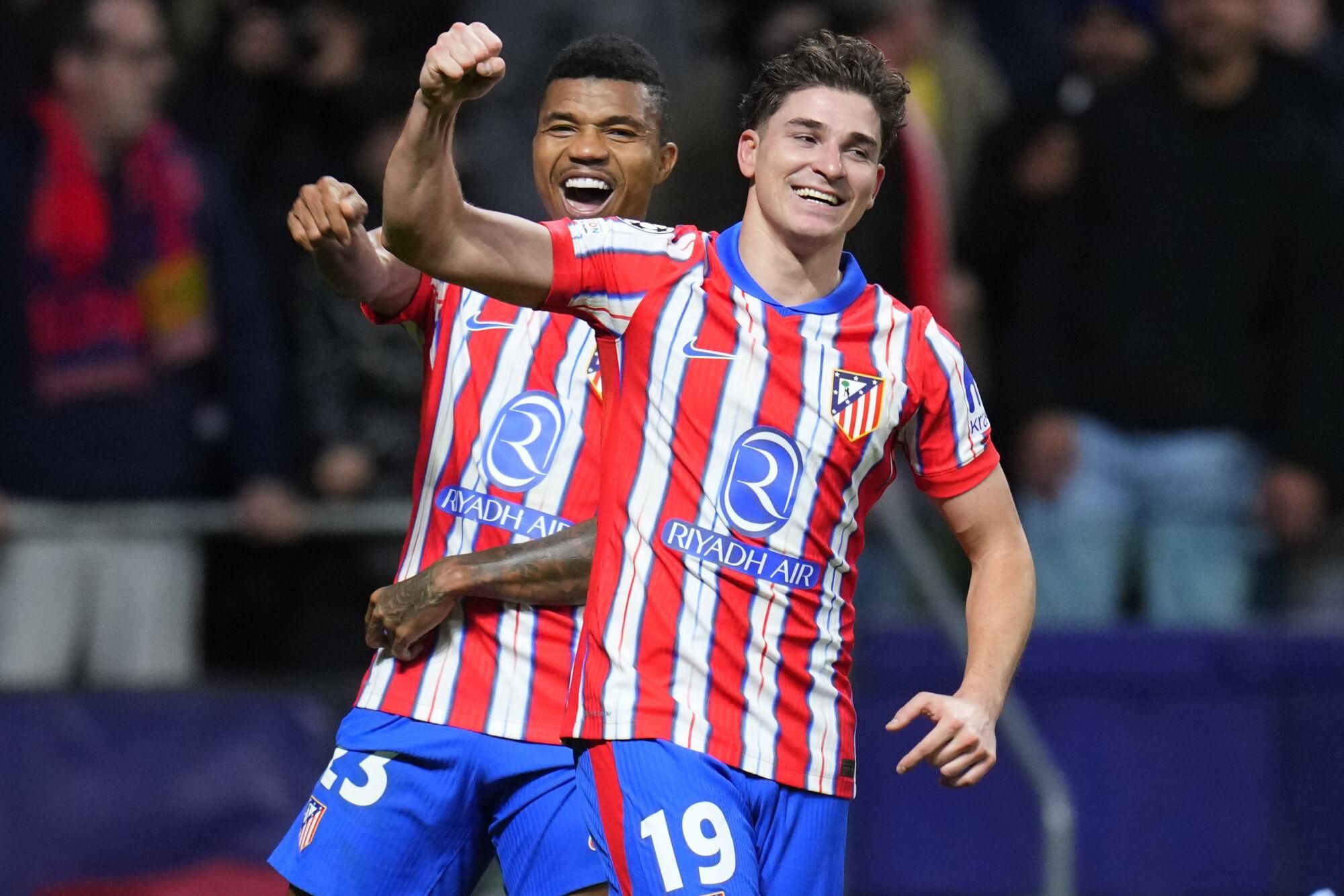 Atletico Madrid's Julian Alvarez, front, celebrates after scoring his side's 2nd goal against Bayer 04 Leverkusen during a Champions League opening phase soccer match at the Riyadh Air Metropolitano stadium in Madrid, Spain, Tuesday, Jan. 21, 2025. (AP Photo/Manu Fernandez). EDITORIAL USE ONLY / ONLY ITALY AND SPAIN