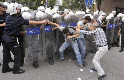 La policía antidisturbios usa gases lacrimógenos para evitar que los manifestantes izquierdistas  marchen hacia el parlamento durante una manifestación contra la guerra en la capital turca de Ankara