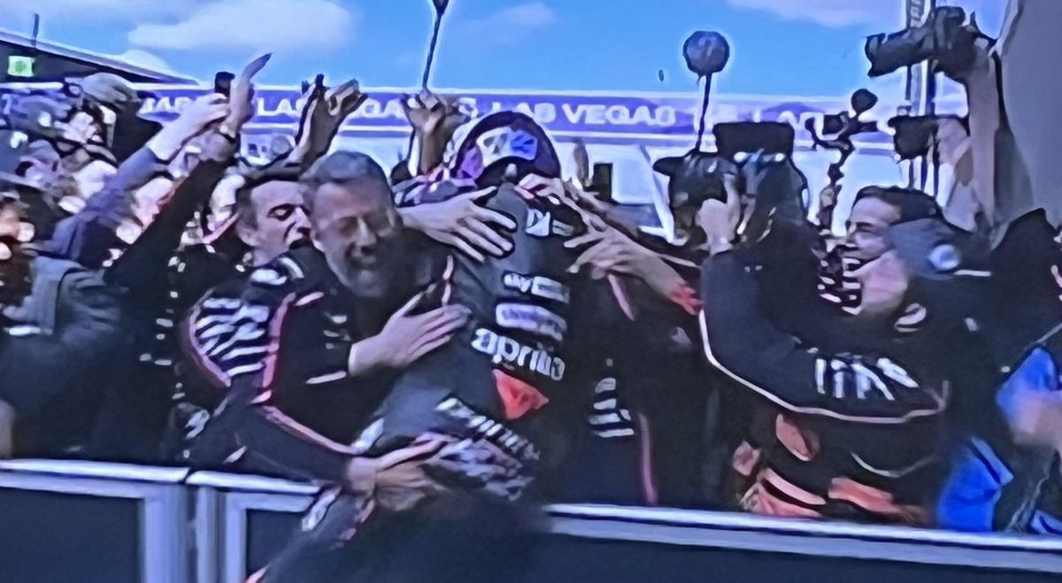 Marc Bezzecchi es abrazado por el equipo Aprilia en el 'corralito' de Silverstone tras su gran victoria.