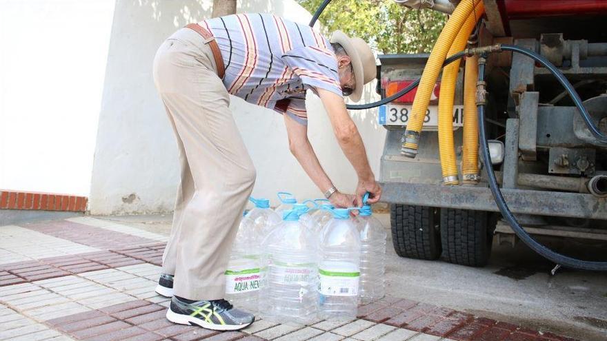 Imagen de uno de los vecinos recogiendo agua de una cuba.