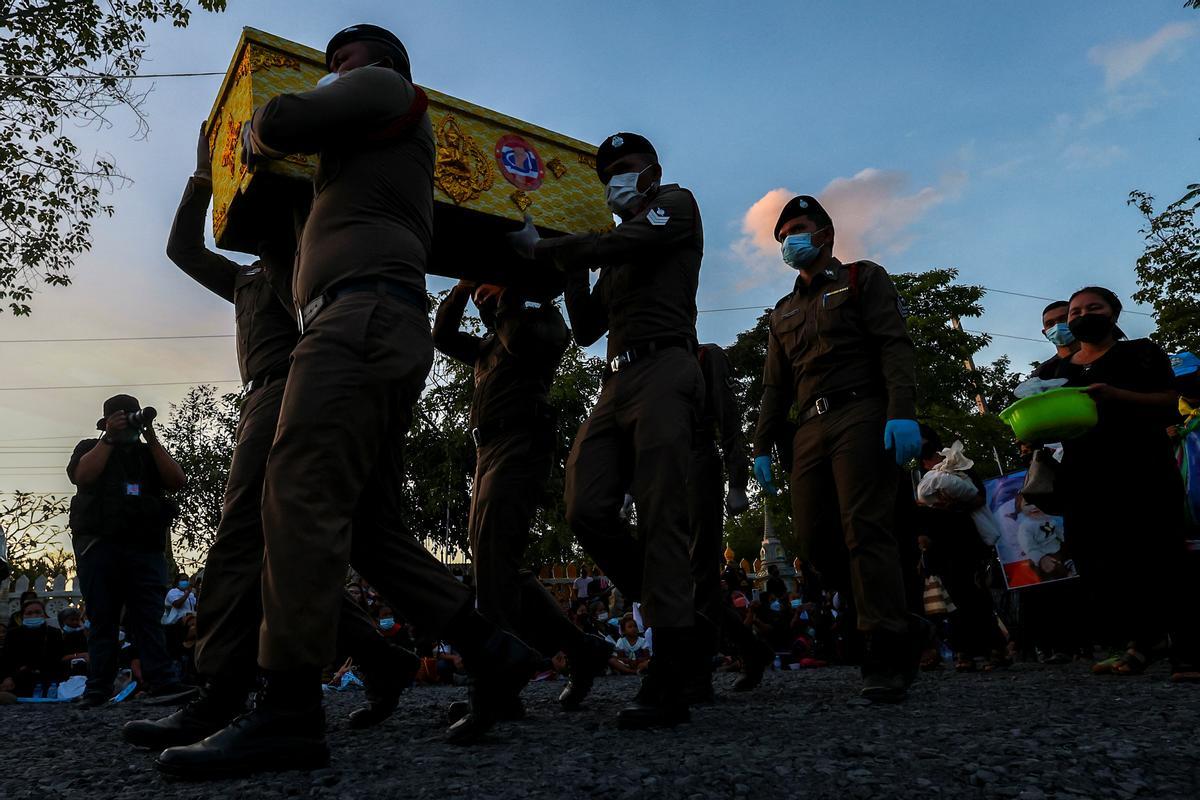 La gente observa cómo las piras funerarias incineran a 19 víctimas del tiroteo en la guardería de Uthai Suwan en el templo Wat Rat Samakee en Uthai Sawan. Un exoficial de policía disparó y mató a 37 personas, al menos 24 de ellos niños, después de irrumpir en una guardería infantil en el noreste de Tailandia.