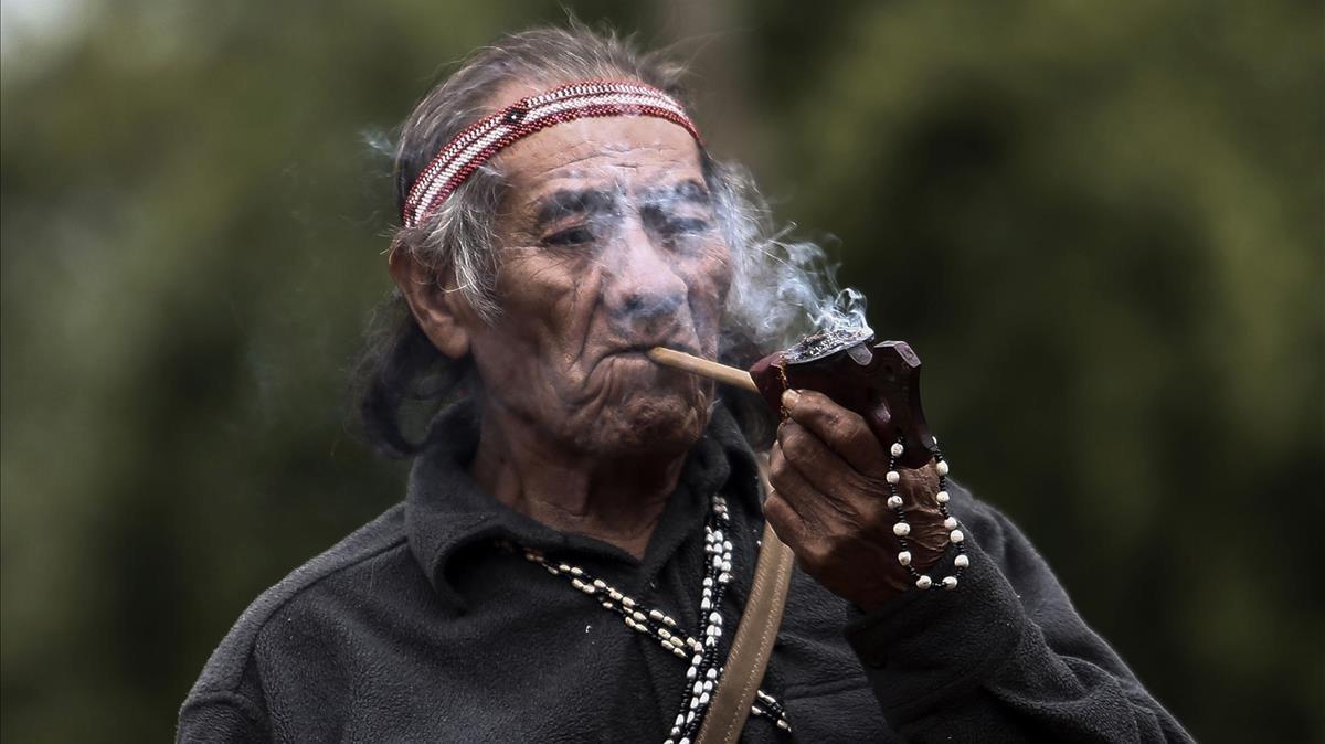 zentauroepp39890823 an indigenous man from a guarani tribe smokes his pipe in th170912142523