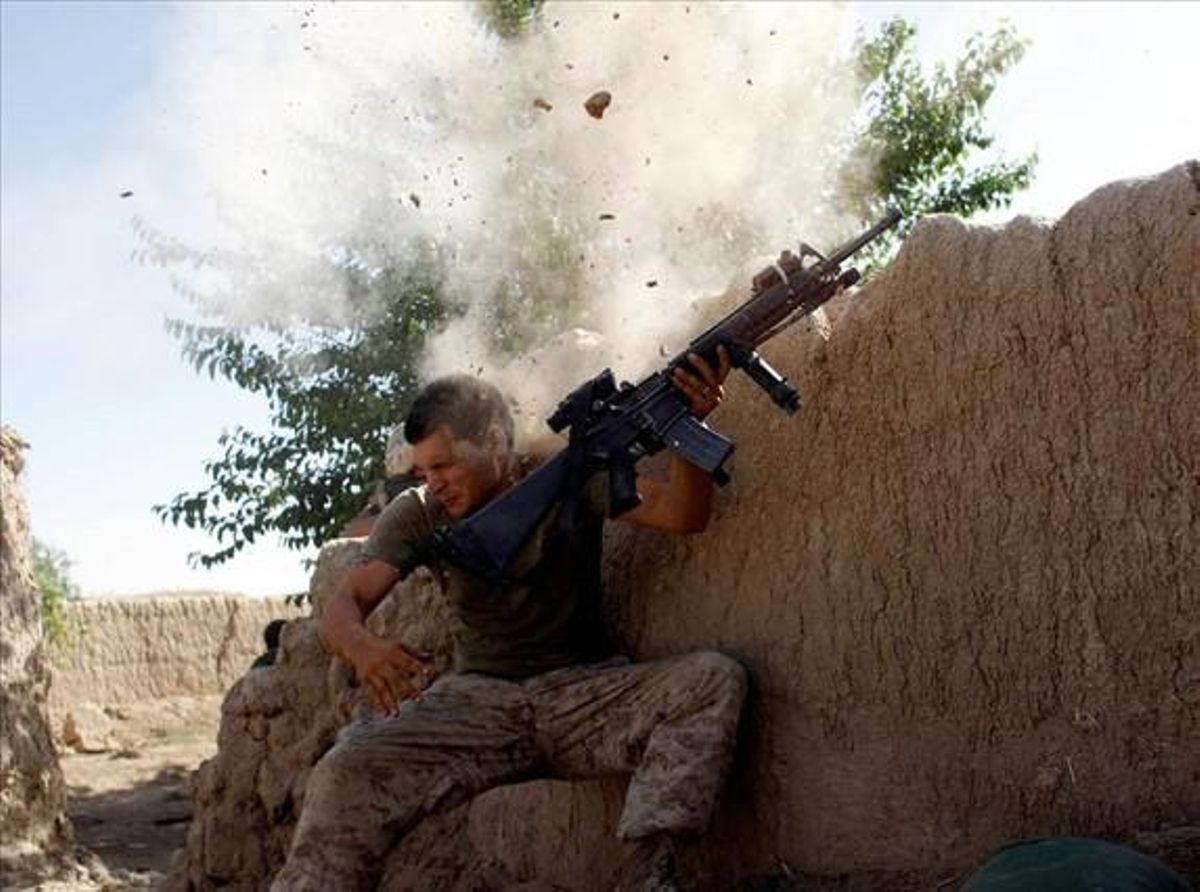 Sgt. William Olas Bee, a U.S. Marine from the 24th Marine Expeditionary Unit, has a close call after Taliban fighters opened fire near Garmser in Helmand Province of Afghanistan May in this 18, 2008 file photo.