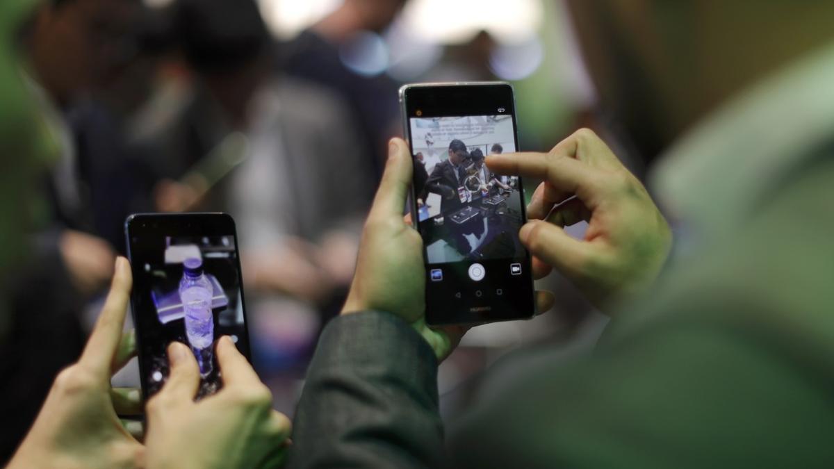 Dos personas manejan sus móviles en el Mobile World Congress de Barcelona, el pasado 27 de febrero.