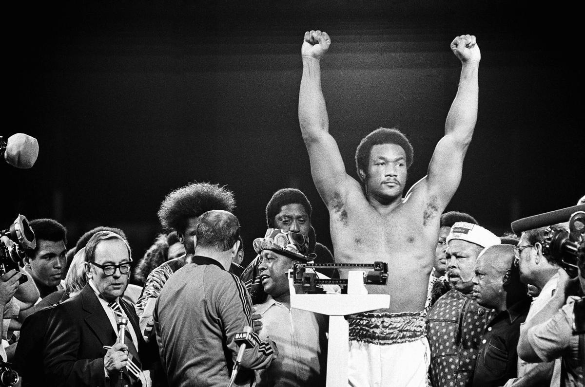 FILE - Heavyweight champion George Foreman responds to cheers of crowd in stadium in Kinshasa, Zaire Saturday night, October 26, 1974 during the weigh in for his title defense against Muhammad Ali. (AP Photo, File). FILE PHOTO