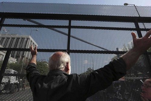 Protester reacts in front of a steel protective fence during a protest march by Greece's Communist party in central Athens at a 24-hour labour strike