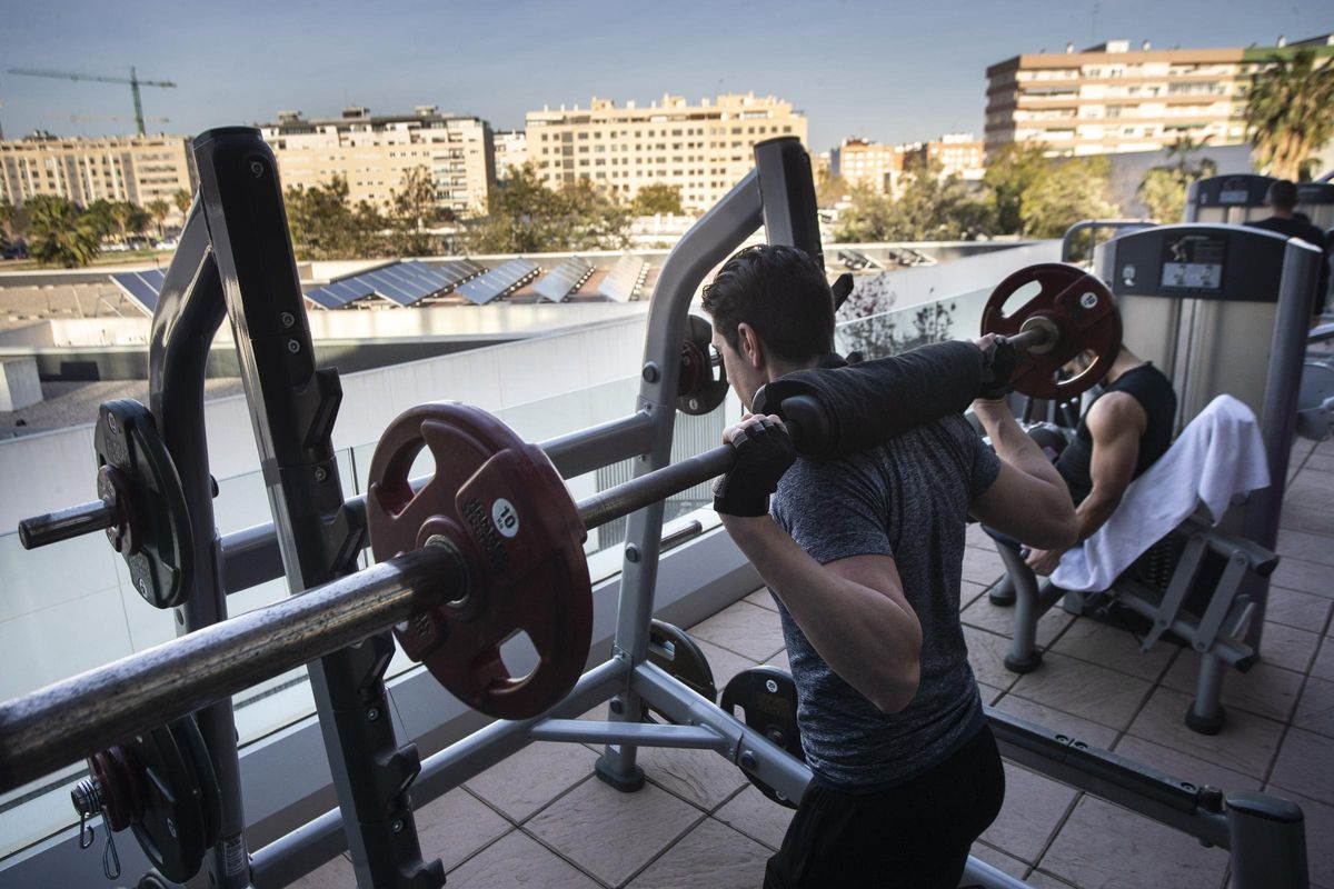 Un par de varones realizando ejercicios de fuerza en un gimnasio de València en una foto de archivo.