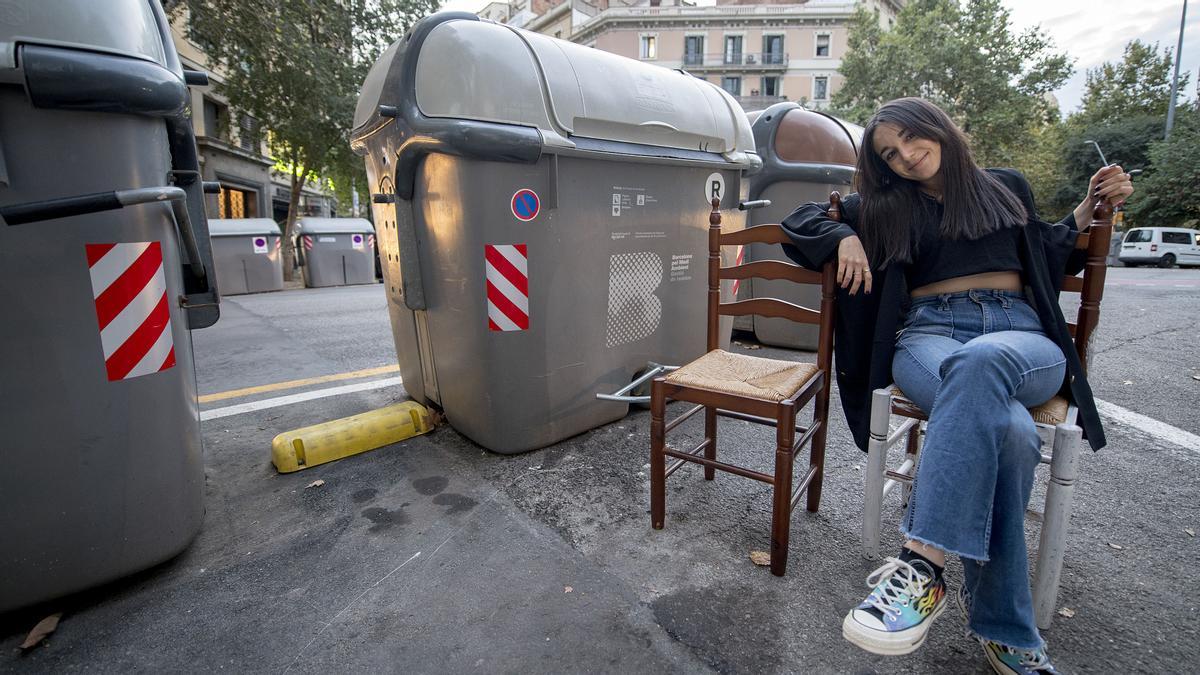 Barcelona. 21.09.2021. Barceloneando by Ana Sanchez. Àngels Florea rastrea los contenedores de las esquinas del Eixamble para descubrir muebles, hacerles una foto y subirla a la cuenta de Instagram https://www.instagram.com/stoopingbcn/ para que la gente los recicle. En la foto, junto a dos sillas descubiertas en provenza/muntaner. Fotografía de Jordi Cotrina