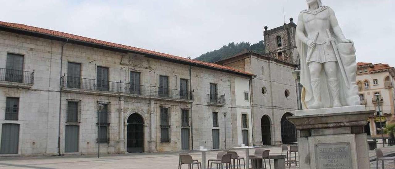 Estatua del rey Silo; al fondo, el palacio de Moutas y la colegiata de Pravia.