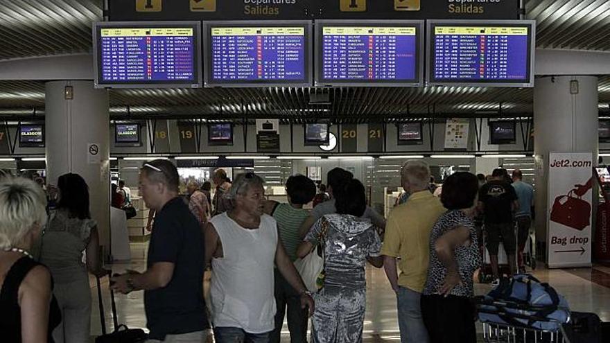 Varios pasajeros esperaban ayer frente a los paneles informativos que reflejaban la cancelaciones.