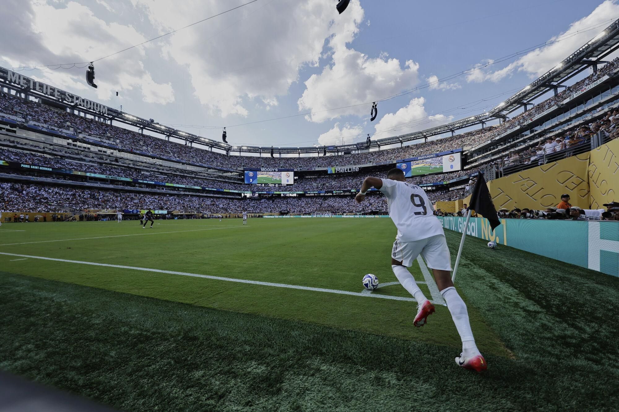 Real Madrid's Kylian Mbappe kicks a corner during the Club World Cup semifinal soccer match between PSG and Real Madrid in East Rutherford, N.J., Wednesday, July 9, 2025. (AP Photo/Adam Hunger)
