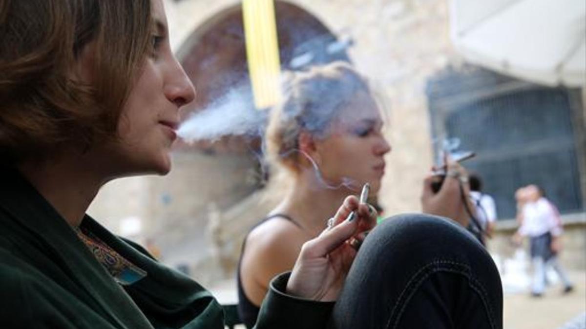 Humo peligroso 8Dos mujeres jóvenes fuman sendos cigarrillos hechos con tabaco de liar, ayer, en el distrito de Ciutat Vella de Barcelona.