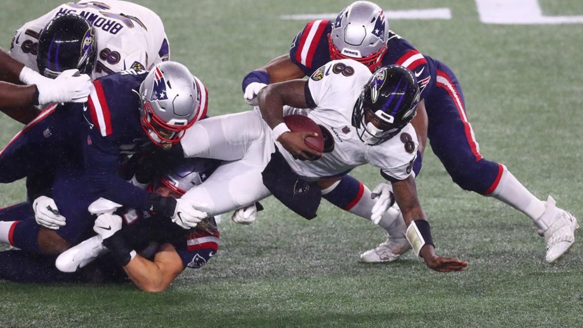 Lamar Jackson # 8 de los Baltimore Ravens es abordado por los New England Patriots durante la primera mitad en el Gillette Stadium.