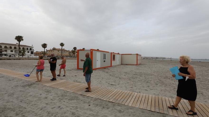 Vecinos junto a las casetas que el club ha instalado en la Playa del Tamarit para ejercer su actividad desde este verano en la nueva zona.  | ANTONIO AMORÓS