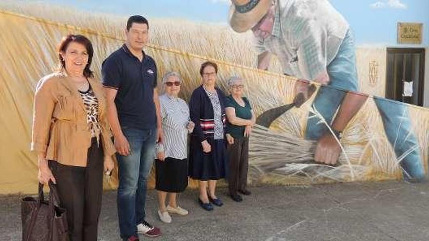 Vecinos posan junto a uno de los murales de &quot;Arte contra el olvido&quot;.