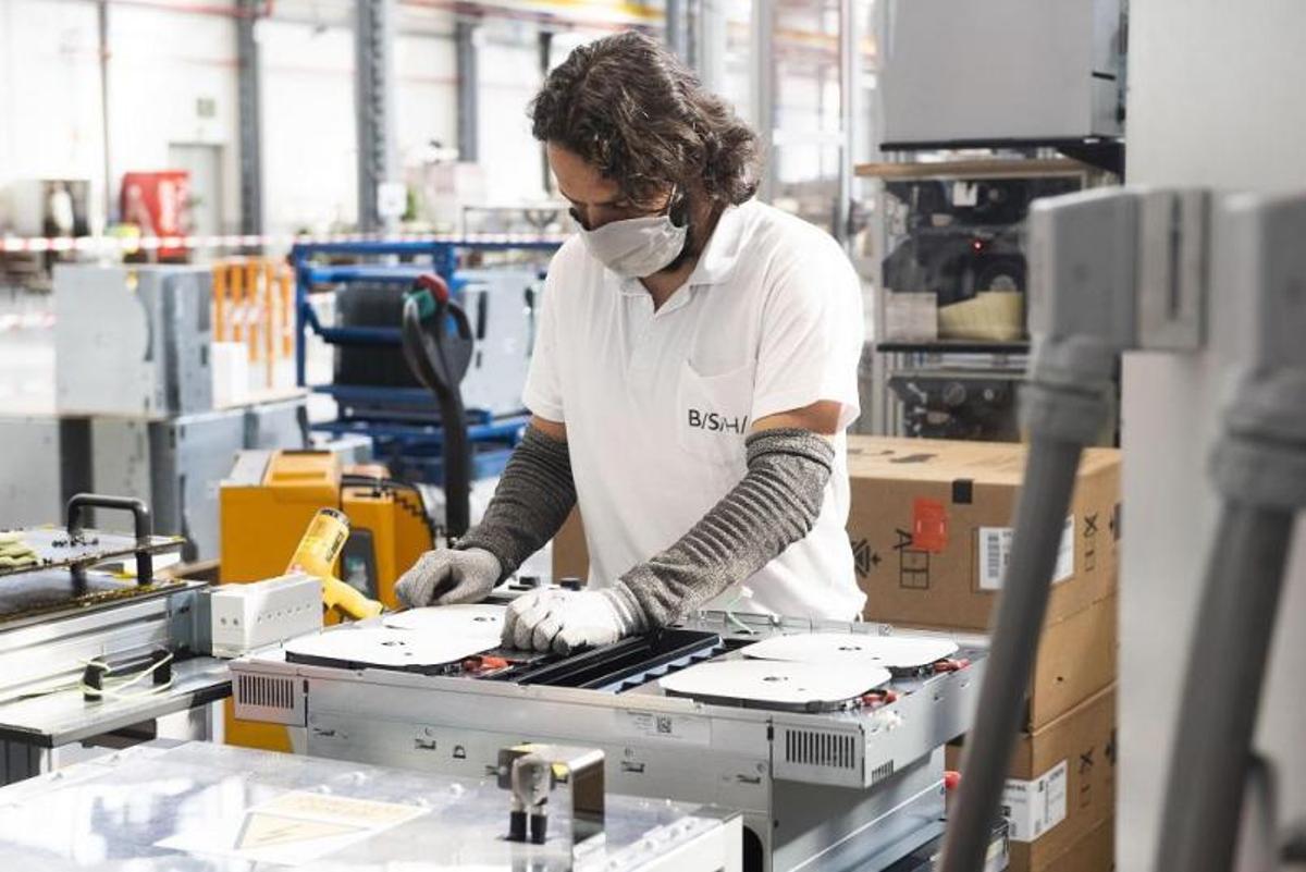 Un trabajador de la línea de producción de placas de inducción de la planta de BSH en Montañana. | BSH