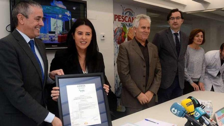 El director de Aenor Galicia y Lupe Murillo sostienen el certificado de calidad de Pescamar. // R. Vázquez