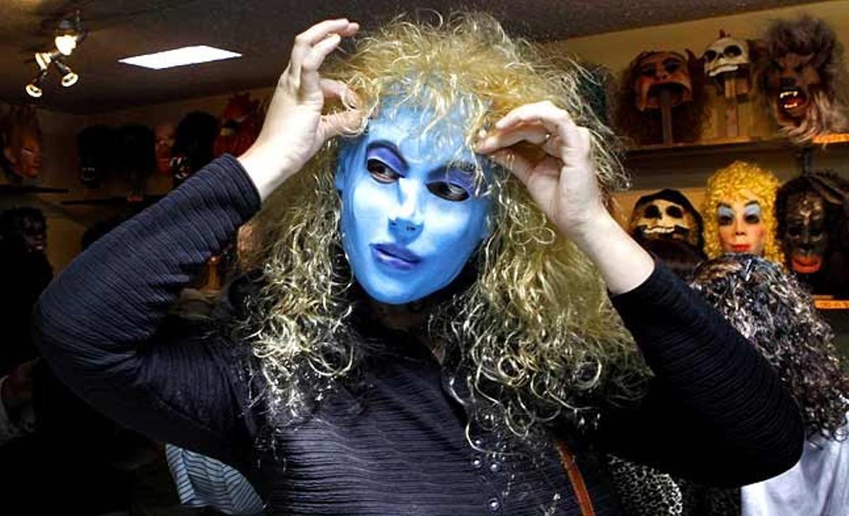 Un client es posa una màscara d’Avatar en una botiga a Quito (Equador). La gent del país crema ninots i màscares per celebrar el Cap d’Any.